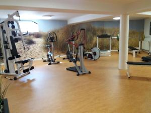 un gimnasio con un montón de equipos de ejercicio en una habitación en Apartment house Jann-Berghaus, Norderney, en Norderney