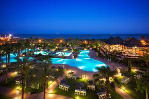 a view of a pool at a resort at night at Puerto Antilla Grand Hotel in Islantilla