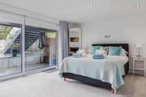 a bedroom with a bed and a large window at Windward in Poole