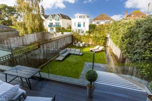 a small backyard with a deck with a garden at Windward in Poole