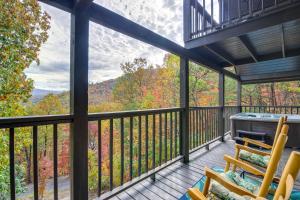 a screened in porch with two chairs and a hot tub at Above and Beyond Pigeon Forge Cabin with Prime Views! in Pigeon Forge