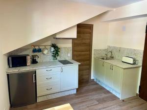 a kitchen with white cabinets and a counter top at Casina Marqués in Cudillero +12 photos