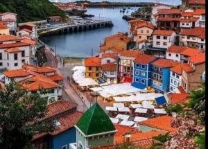 a view of a town with a river and buildings at Casina Marqués in Cudillero