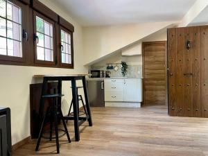 a kitchen with a table in the middle of a room at Casina Marqués in Cudillero