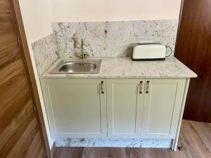 a kitchen counter with a sink and a toaster at Casina Marqués in Cudillero
