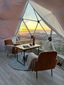 a table and chairs in a tent with a view at Forbord Dome 