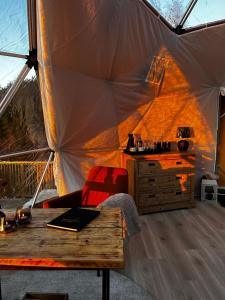a room with a tent with a table in it at Forbord Dome in Tilleraune +32 photos