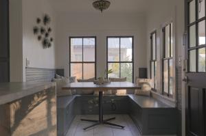 a living room with a table and some windows at Clinton House - Master in Lafayette