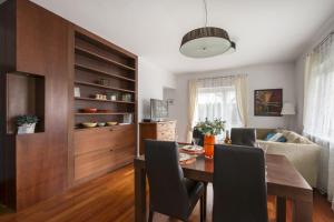 a dining room with a table and a couch at M&R Apartament Airport&Business Premium Marina Mokotów - parking - WiFi - Netflix - self check-in, terrace - guarded estate - WAW Chopin Airport in Warsaw