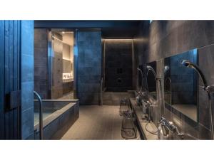a bathroom with a shower and a tub and a sink at ＳＡＵＮＡ&ＳＴＡＹ - Vacation STAY 80243v in Setouchi