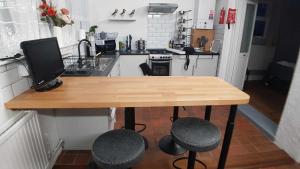 a kitchen with a table with a computer on it at Puffin Place,Lloyd House in Haverfordwest