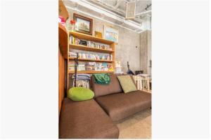 a living room with a couch and a book shelf at Little Okawood - Vacation STAY 83130v in Ōkawa