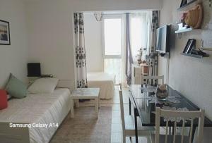 a small living room with a couch and a table at Résidence au soleil avec Piscine à 150m de la plage - Barcarès in Le Barcarès
