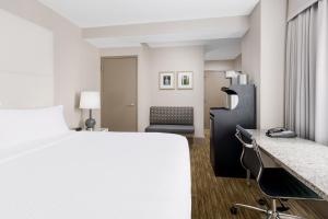 a hotel room with a bed and a desk at Holiday Inn Express Chicago - Magnificent Mile by IHG in Chicago +29 photos