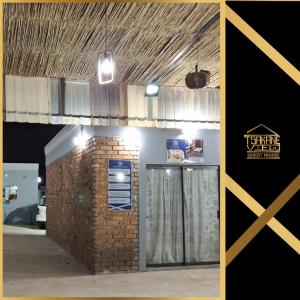 a brick building with a door and a sign on it at Tsakane View Guesthouse in Brakpan +6 photos