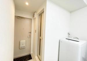 a white bathroom with a toilet and a sink at Beverly Homes Osaki Room 203, Room 205, Room 301, - Vacation STAY 89039v in Tokyo