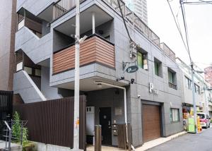 a building on a street with a garage at Princet Shinjuku Building - Vacation STAY 15549 in Tokyo