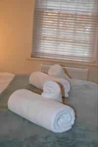a group of towels on top of a bed at Entire apartments in the heart of the Suffolks - GL50 Apartments in Cheltenham