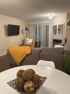 a living room with a couch and a table at Cozy Condo at the Lake in Sylvan Lake