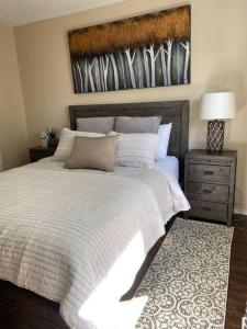 a bedroom with a large bed with a white bedspread at Cozy Condo at the Lake in Sylvan Lake