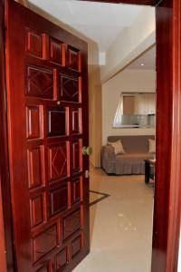 a door leading to a living room with a couch at Elpidas Apartment in Kalabaka