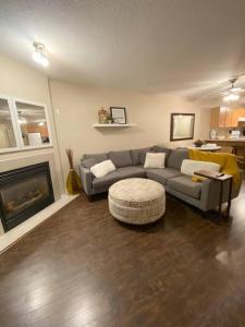 a living room with a couch and a fireplace at Cozy Condo at the Lake in Sylvan Lake