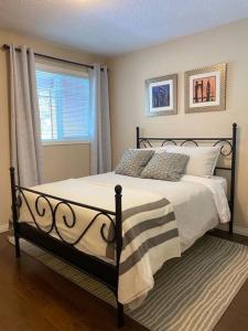 a bedroom with a bed and a window at Cozy Condo at the Lake in Sylvan Lake