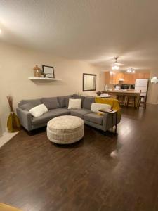 a living room with a couch and a table at Cozy Condo at the Lake in Sylvan Lake