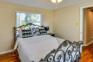 a bedroom with a large white bed with a window at Tuskegee Countryside Retreat on 7 Acres! in Tuskegee