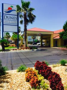 a sign for a dunes inn and suites at Dunes Inn & Suites - Tybee Island in Tybee Island