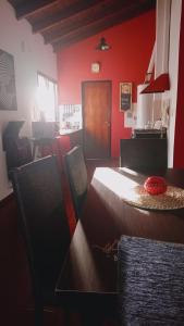 a dining room with red walls and a table and chairs at Complejo Cerrado Zona Shopping in Guaymallen
