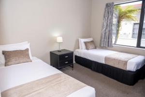 a bedroom with two beds and a window at 58 On Cron Motel in Franz Josef