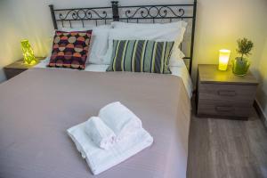 a bedroom with a bed with two towels on it at Grandis Rooms in Rome