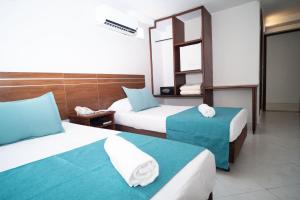 Postel nebo postele na pokoji v ubytování Hotel Portobelo Convention Center