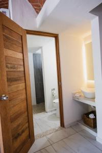 a bathroom with a toilet and a sink at Paulas Suites Terraza in Ixtapa