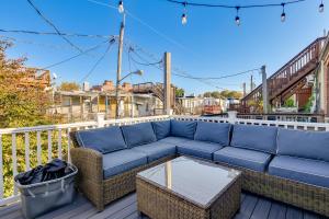 a blue couch on a deck with a table at Trendy Baltimore Townhome 2 Mi to Downtown! in Baltimore