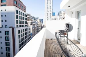 a balcony with a view of a building at WeSleep Paraguay Departamentos en Microcentro in Buenos Aires