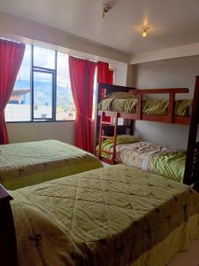 a bedroom with two bunk beds and a window at Hotel Anturios in San Miguel