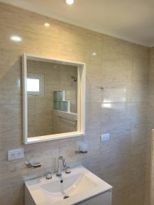 a bathroom with a sink and a mirror at Casa a estrenar en Santa Elena - Santa Clara, Costa Atlantica in Playa Dorada