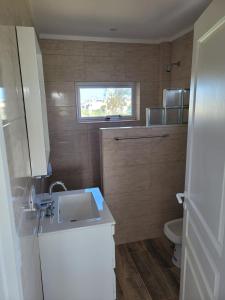a small bathroom with a sink and a toilet at Casa a estrenar en Santa Elena - Santa Clara, Costa Atlantica in Playa Dorada