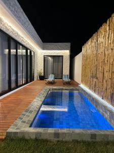 a swimming pool in the backyard of a house at Casa Nazar in São Miguel dos Milagres