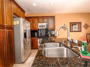 a kitchen with a sink and a stainless steel refrigerator at Beautiful San Felipe Getaway in La Ponderosa