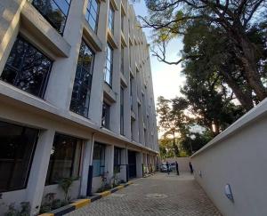 a building with people walking in front of it at A tastefully furnished one bedroom airbnb apartment along Thika rd, TRM mall in Nairobi