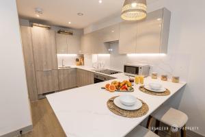 a kitchen with a counter with a bowl of fruit on it at Brand new town centre, sleeps 4 & WI-FI - Vespasian's Abode in Poole