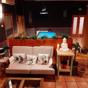 a living room with a couch and a candle on a table at Hostal Tastavins in Peñarroya de Tastavins