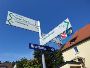 a street sign with street signs on a pole at Fewo Fulda Neuenberg in Fulda
