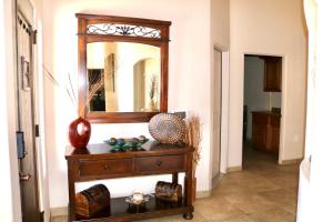 a wooden dresser with a mirror on a wall at Southwestern Comfort Stay 2B in Las Cruces