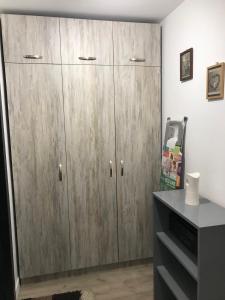 a pair of wooden cabinets in a room at Cozy loft apartment in Pleven