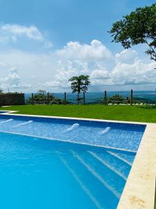 a swimming pool with a view of the ocean at Ecohotel La Reserva in Piojó