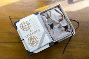 a box with two watches sitting on a wooden table at Il Viterbino Struttura convenzionata con impianti termali in Viterbo